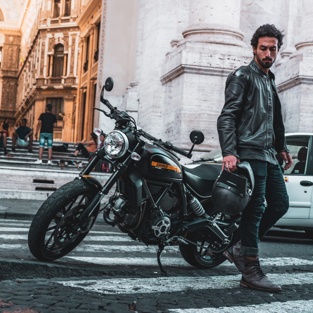 Man riding motorcycle through Italy with Racered